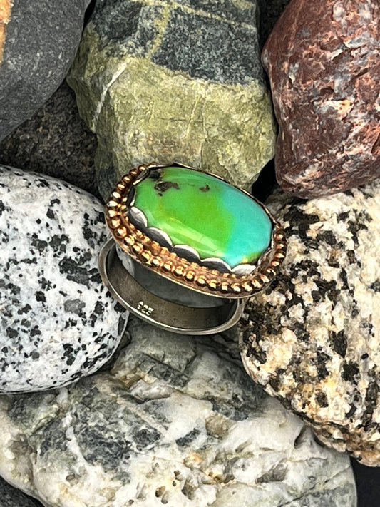 Ring with a Sonoran Gold turquoise stone on a bed of rocks