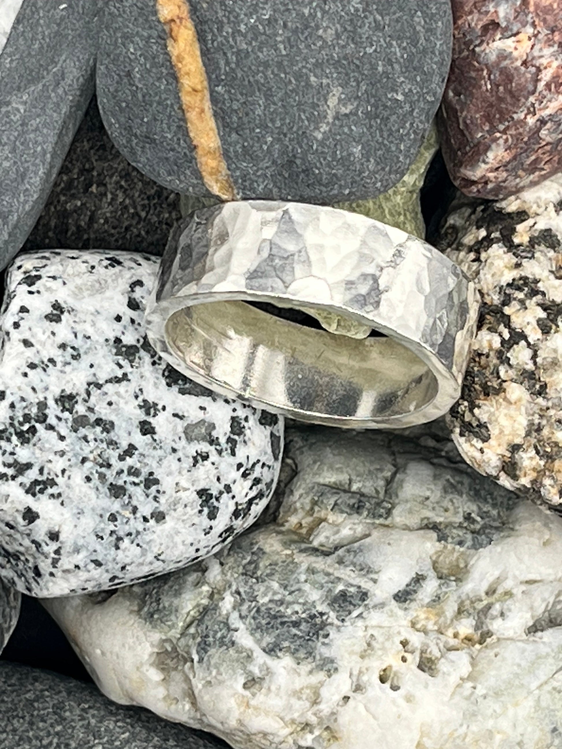 Silver ring on a bed of stones