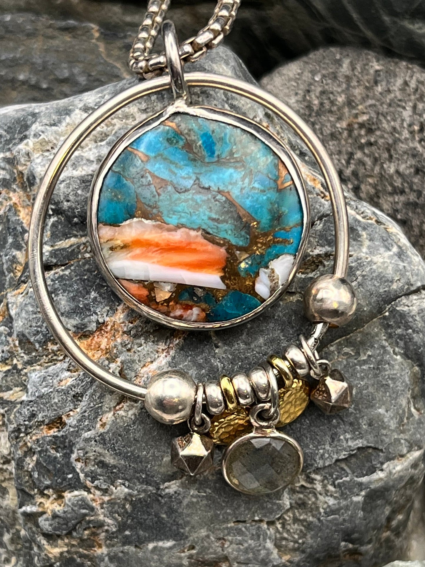 Jewelry with a stone pendant on a rocky surface